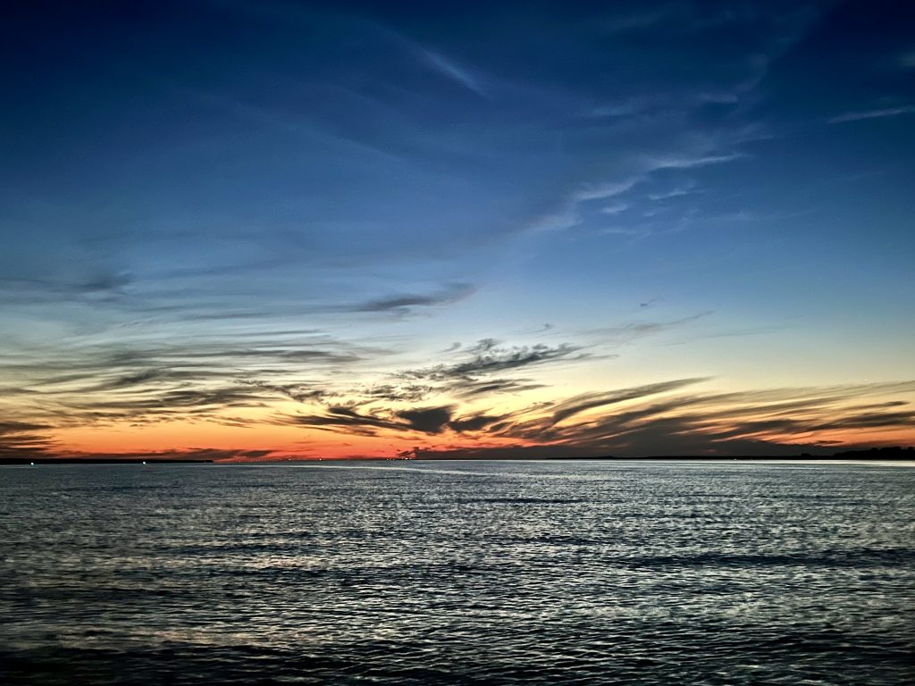 A colorful sunset over Lake Huron with Round Island in the background.
