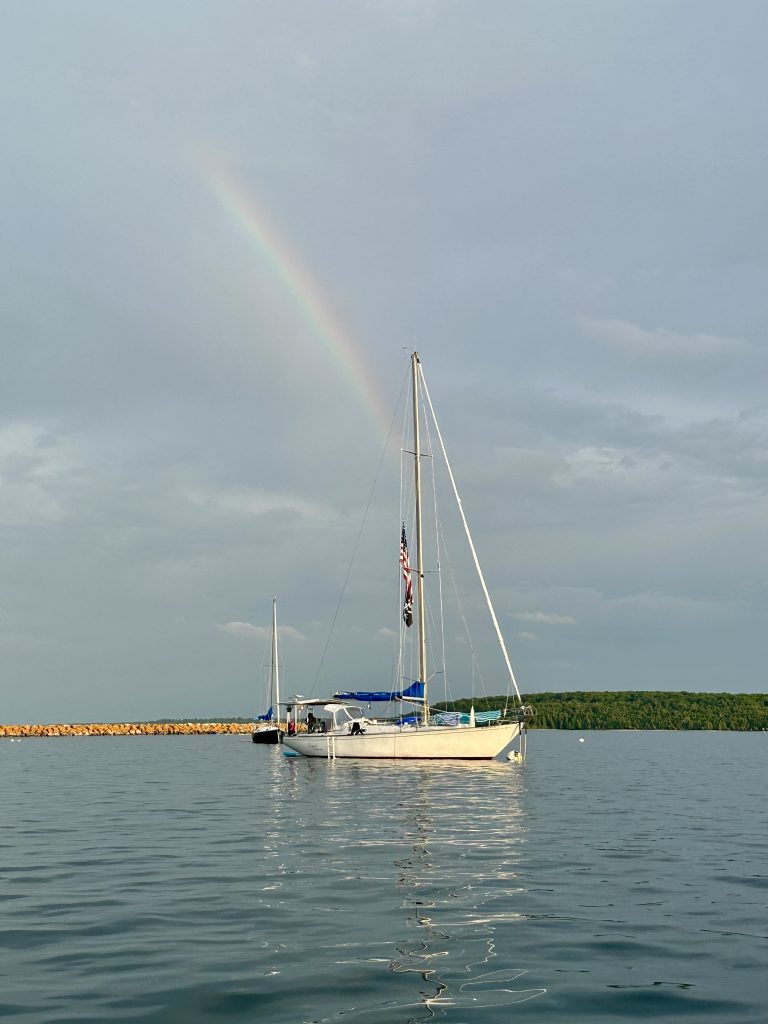 Sailboat anchored near Mackinac Island, perfect for custom sailing trips.