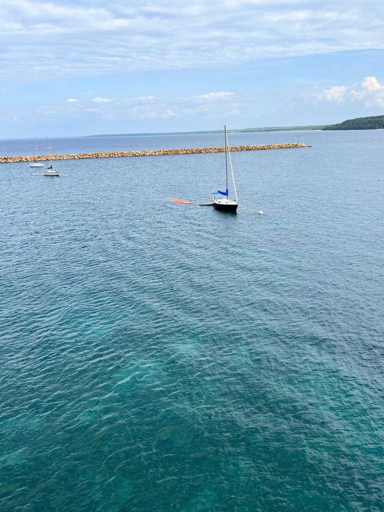Sailboat docked near Mackinac Island, ready for Lake Huron sailing charter.