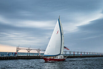Close-up of Windy Escape sailboat under sail near Mackinac Island, offering private sailing charters on Lake Huron.